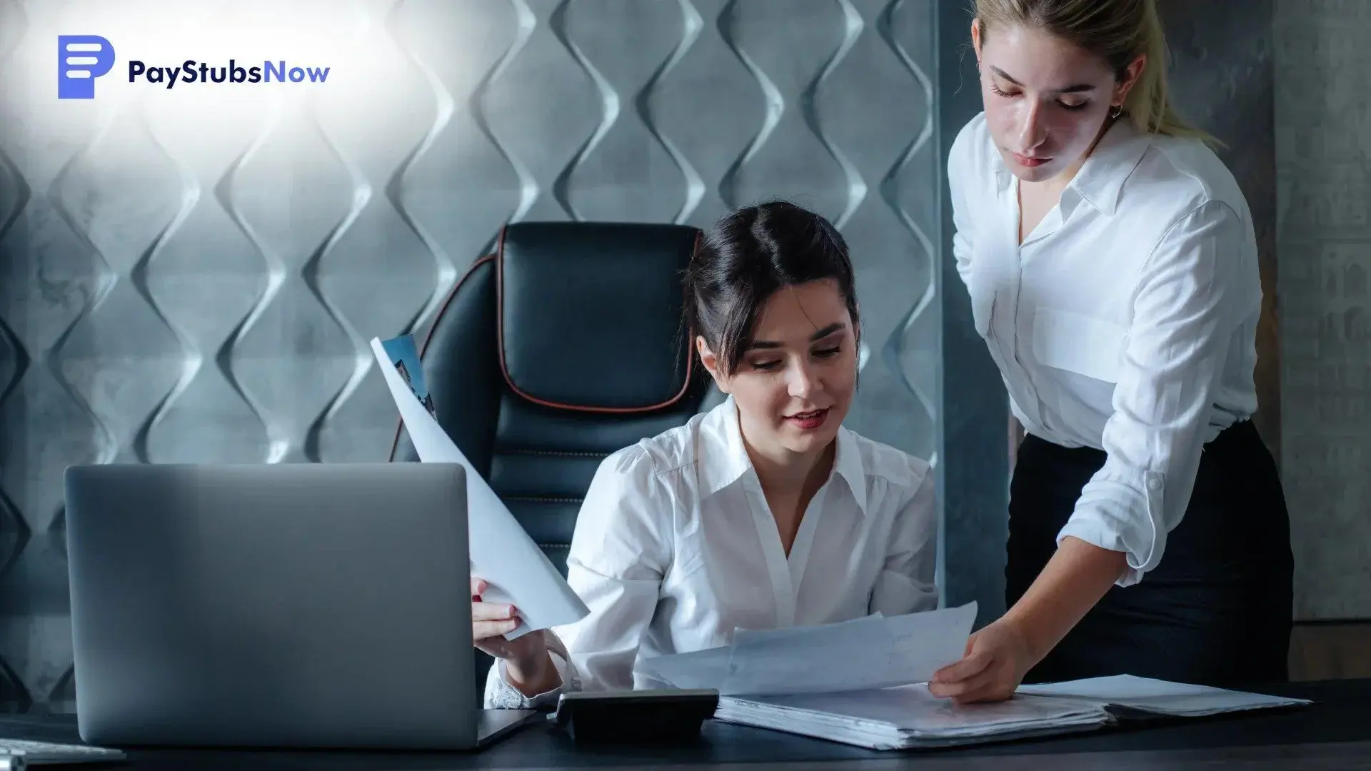 Two women reviewing paperwork to understand what the W-2 deadline covers for different roles in the company.