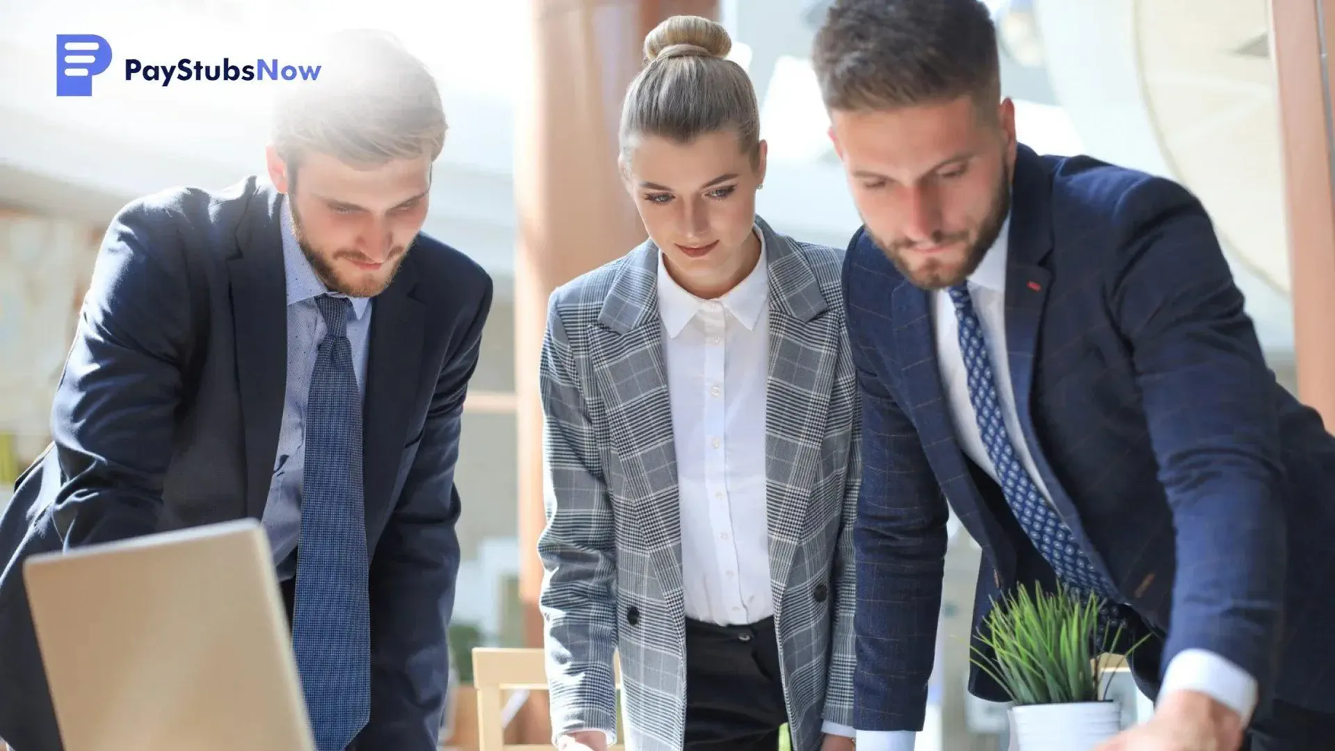 Three professionals in business attire looking closely at a laptop to discuss where to file and how to deliver.